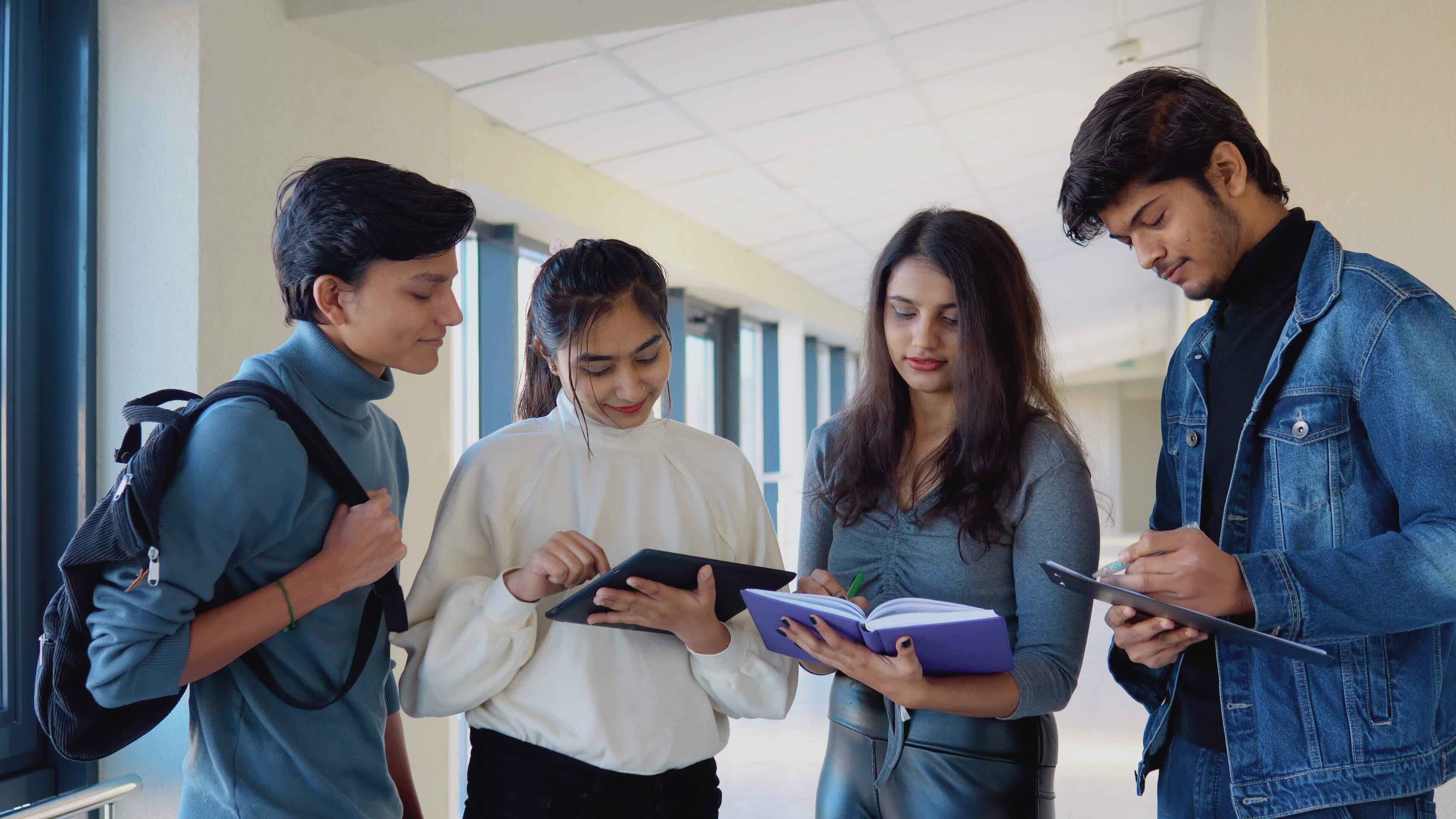 a-group-of-indian-students-with-books-and-a-tablet-at-the-university-education-concept-video